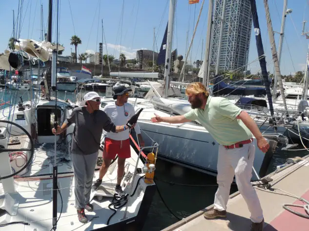 Alberto de Castro y José Luis Francés, recibiendo la botella de cava, como primeros llegados a la meta y vencedores en tiempo real de la regata Mil Millas.